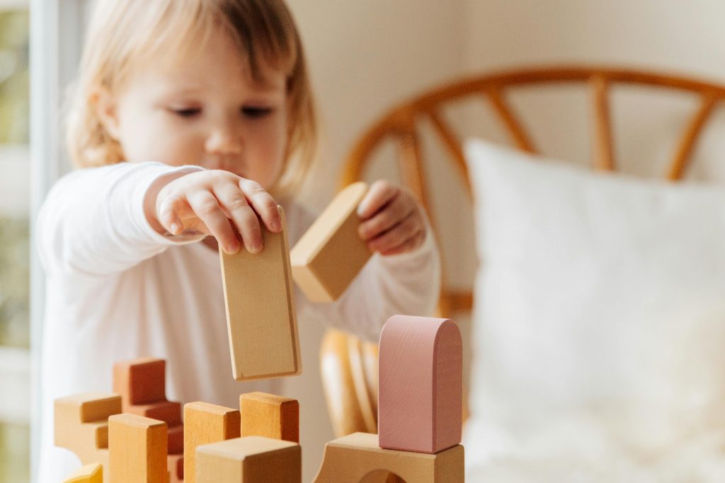 toddler stacking wooden blocks